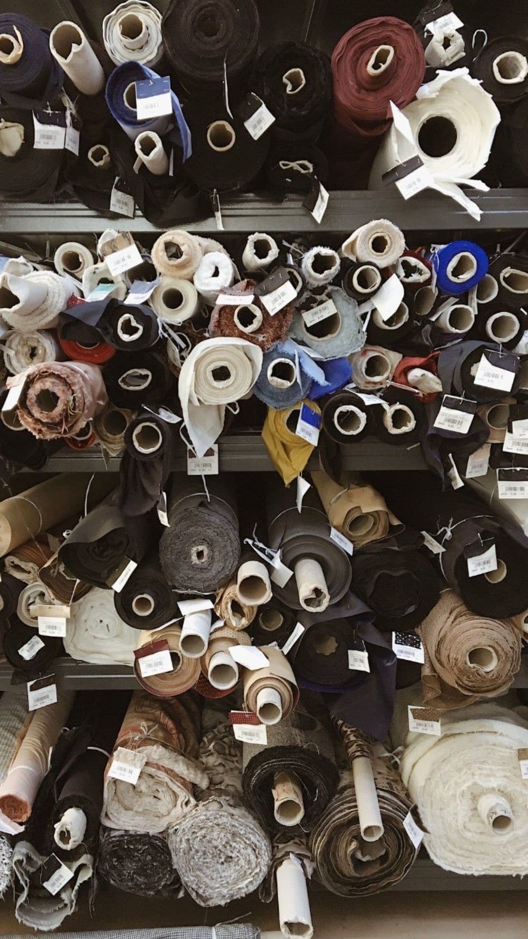 Shelves stacked with rolls of fabric
