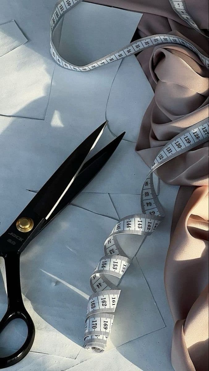 Tailoring detail: scissors, measuring tape, and fabric