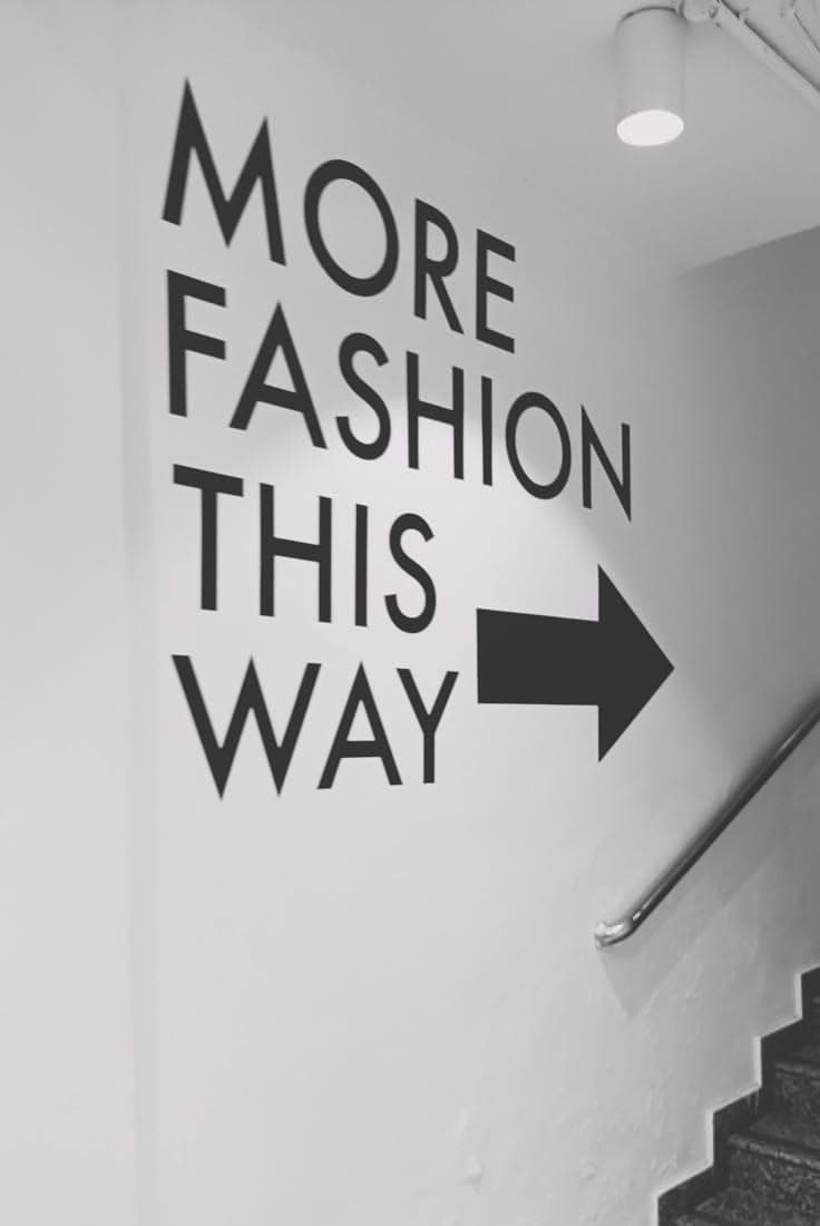 Wall graphic reading 'More fashion this way'